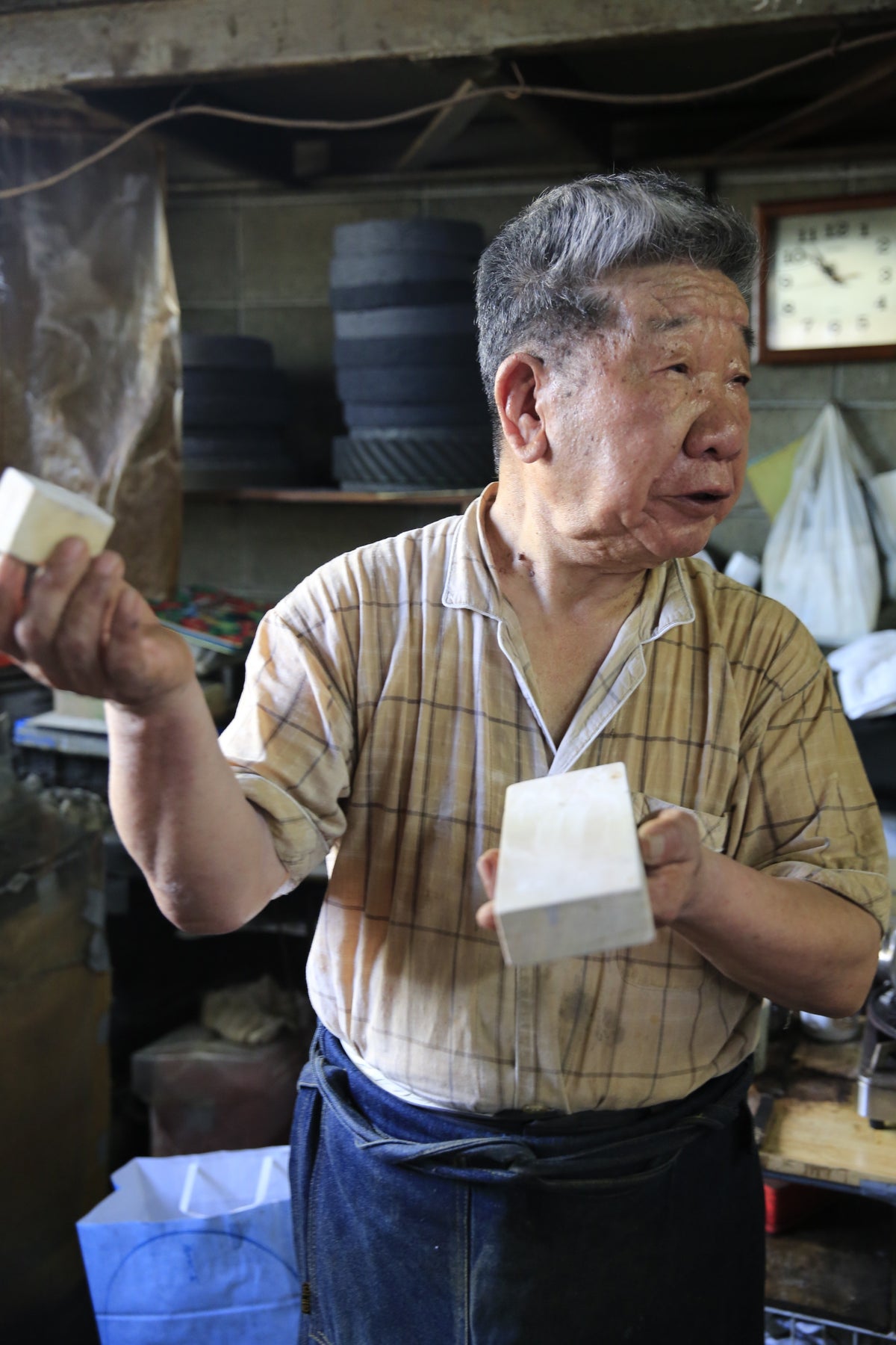 Yukinori Oda with his finishing stones at the Sakai Takayuki factory, 2014
